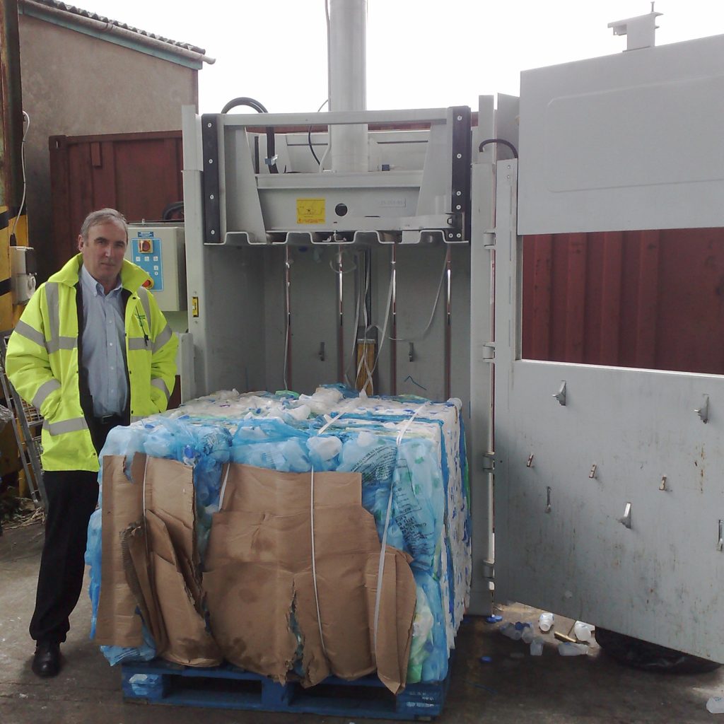 Plastic bale ejected from the mill baler onto a pallet.

